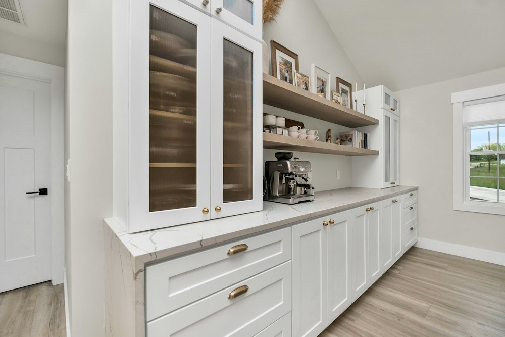 White custom cabinetry with glass doors
