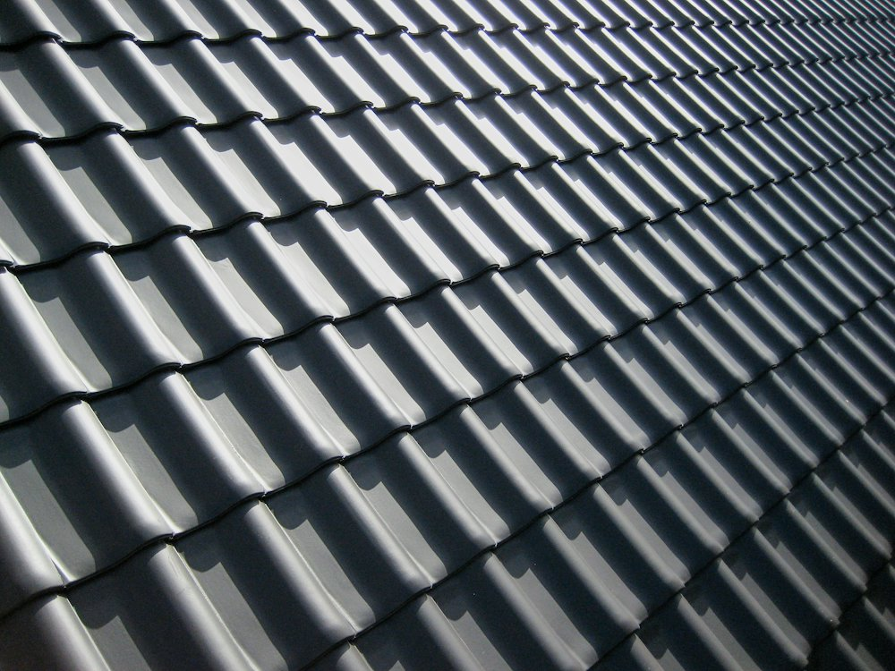 Dark profiled roof tiles